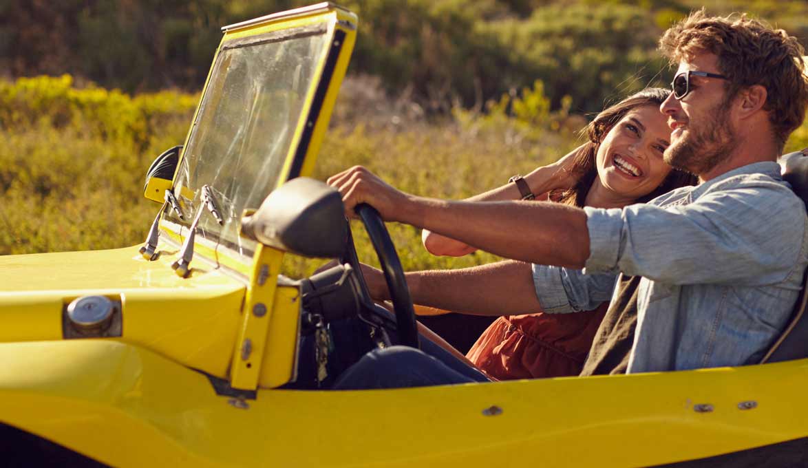 Couple driving with top down.